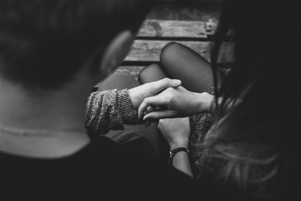 Touchstone Psychology a couple is sitting and holding hands
