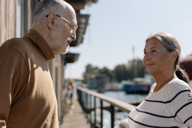 older couple talking on a balcony