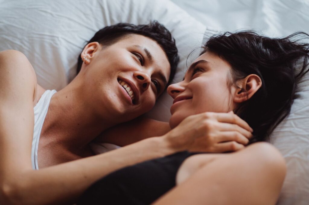two-women-in-bed-looking-at-each-other